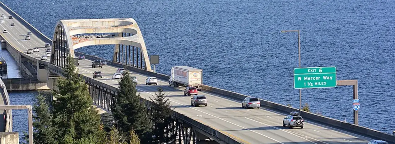 Interstate 90 Lake Washington bridges from East Portal Viewpoint, Seattle, Washington, including sign for Mercer Island exit.
